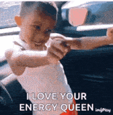 a young boy in a car with the words i love your energy queen on the bottom