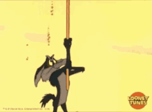coyote from looney tunes is hanging from a pole .