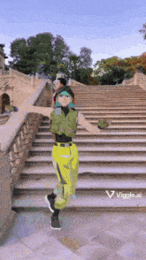 a person is standing on a set of stairs with a viggle.com logo on the bottom right