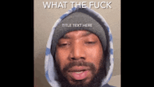 a man with a beard wearing a hoodie and a beanie says what the fuck .