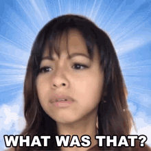 a woman says what was that in front of a blue background