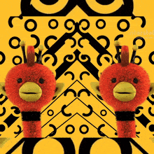 two stuffed animals are standing in front of a yellow background with circles