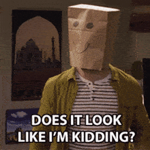 a man wearing a paper bag on his head says does it look like i 'm kidding