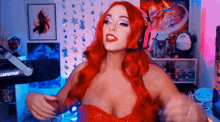 a woman with red hair is wearing a red dress and headphones .