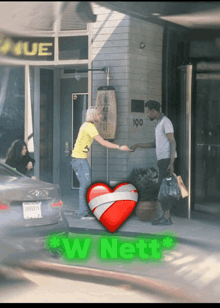 a man shakes hands with a woman in front of a building that says 100 on it