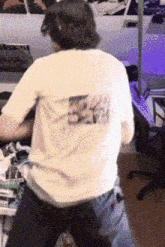 a person wearing a white t-shirt with a picture on the back of it
