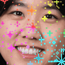 a close up of a woman 's face with colorful pixelated stars around her