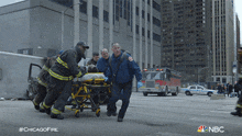 Rescuing A Patient Chicago Fire GIF - Rescuing A Patient Chicago Fire Saving A Patient GIFs