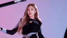 a woman with long blonde hair is wearing a black jacket with a bow tie .