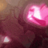 a close up of a pink glowing object in a dark room