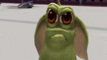 a green cartoon character with big eyes and ears is standing on a ice rink .