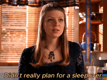 a woman says " didn t really plan for a sleepover " in front of a window