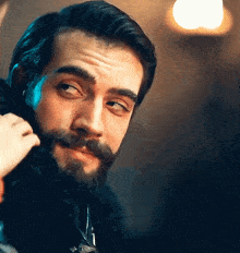 a man with a beard and mustache is looking to the side