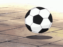 a soccer ball is floating in the air on a tiled floor