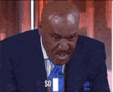 a man in a suit and tie says say on the screen