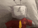a stuffed animal with a tv logo on his shirt and tie