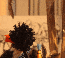 a close up of a person 's head with a bottle in front of them