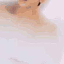 a man and a woman are taking a bath together and the woman is looking at the camera .