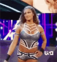 a female wrestler is standing in front of a usa logo .