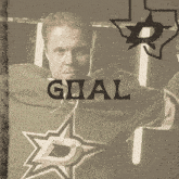 a man wearing a goal jersey stands in front of a texas star logo