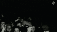 a black and white photo of a crowd of people with the letter f in the upper right corner