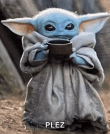 a baby yoda is holding a cup of coffee in his hands .