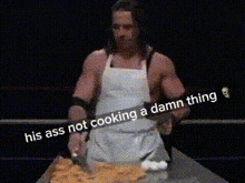 a man in an apron is standing in front of a table with food and a caption that says his ass not cooking
