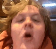 a woman is making a funny face with her mouth open .