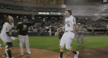 a baseball player with the number 16 on his jersey is running on the field