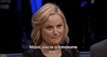 a woman says " maya you 're a handsome man " in front of a man