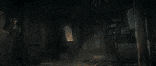 a person standing in a dark room with a glowing object behind them
