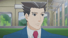 a man in a suit and tie is sitting in a train