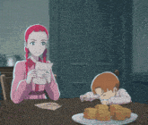 a boy and a girl are sitting at a table with a plate of cookies in front of them