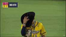 a baseball player wearing a yellow jersey that says bananas