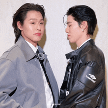 two men are standing next to each other and one has a balenciaga jacket on