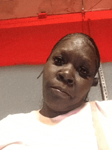 a woman in a white shirt looks at the camera