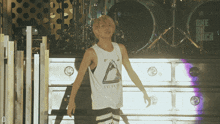 a man stands in front of a drum set that says one ok rock on it