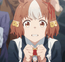 a close up of a girl with the letter b on her ear
