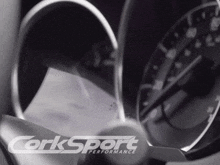 a corksport performance ad with a steering wheel