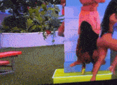 a tv screen shows a woman doing a handstand