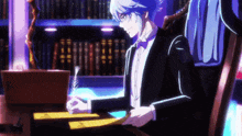 a man in a tuxedo is sitting at a desk writing with a pen .