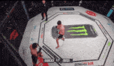a man in a boxing ring with a monster energy drink can on the mat