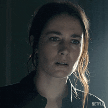 a close up of a woman 's face with netflix written on the bottom right