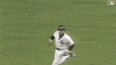 a man in a baseball uniform is running on a field surrounded by people