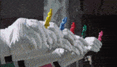 a row of white gloves with colored fingers on them