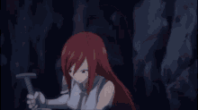 a woman with red hair is holding a sword and making a funny face