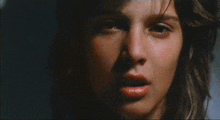 a close up of a woman screaming with her mouth wide open