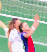 a blurred image of a volleyball game with two players