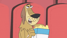 a cartoon dog is eating popcorn while sitting in a theater