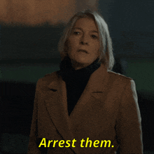 a woman in a coat says arrest them